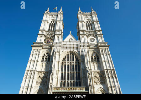 Bright sunny exterior view of Westminster Abbey under blue sky in London, UK Stock Photo