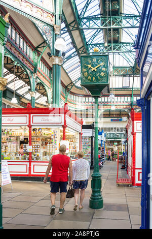 Indoor stalls and clock at Leeds Kirkgate Market, Kirkgate, Leeds, West Yorkshire, England, United Kingdom Stock Photo