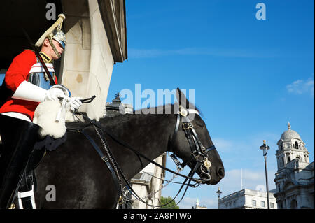 LONDON - JUNE 23, 2011: A mounted Life Guard of the Household Calvary sits on a black horse in Whitehall. Stock Photo