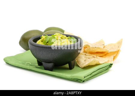 Bowl of fresh homemade guacamole with crispy tortilla chips. Stock Photo