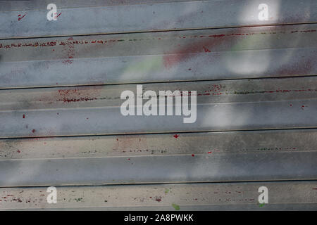 Weathered and distressed painted corrugated metal background Stock Photo