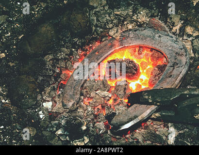 Smith furnace. Hot metal handmade unique iron rose in forge stove Stock Photo