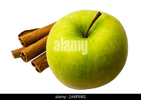 Green apple with cinnamon sticks close up Stock Photo