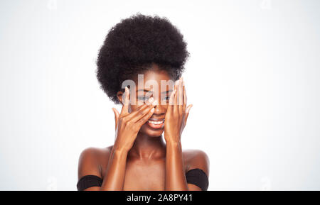 Smiling Afro Model in Beauty Concept Covering Face With Hands. Stock Photo