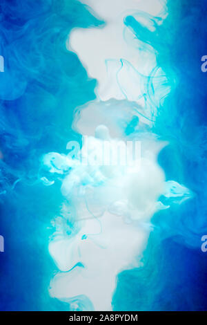 Blue ink waves in white fluid on white background Stock Photo