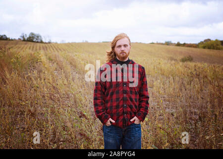 Young Man With Long Red Hair and Beard Outside in the Country Stock Photo