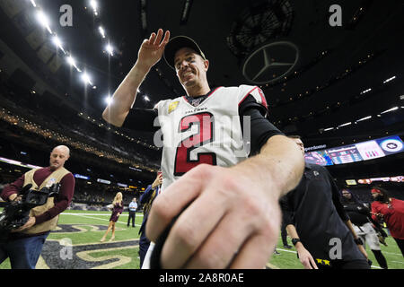 Atlanta Falcons quarterback Matt Ryan (left) walks of the field after Chicago  Bears defensive back Tashaun Gipson Sr. (Photo by top right) intercepted  his pass intended for Calvin Ridley for the turnover