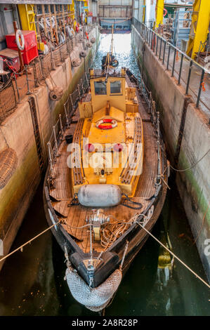 The D49 diesel Harbour Service Launch built in 1956 moored in Boathouse 4 of Portsmouth Historic Dockyard. Stock Photo