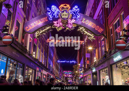 LONDON, UK - 11TH NOVEMBER 2018: Carnaby Street Christmas decorations in 2018. In a Bohemian Rhapsody theme. Lots of people can be seen. Stock Photo