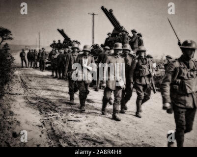 German prisoners of war escorted to the rear lines on the Black day of 8th August 1918. Earlier in March 1918, the Germans launched their Spring Offensive, consisting of four different major battles between March and July, that drove the Allies reeling back more than 50 miles. In the early morning hours of August 8, 1918, the German Army, depleted and exhausted by months of attacking, were taken completely by surprise when the British Fourth Army attacked and, by the end of the day, had punched a hole 15 miles wide in the front. Stock Photo