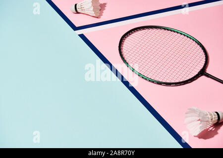 Badminton racket and shuttlecocks on colorful surface with blue lines Stock Photo