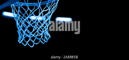 Basketball hoop isolated on black background. Blue filter Stock Photo