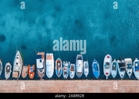 Aerial view of the fishing boats and yachts on tropical sea coast Stock Photo