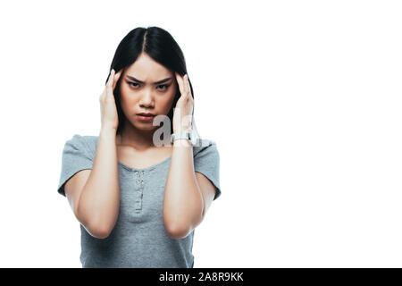 attractive asian girl suffering from migraine isolated on white Stock Photo