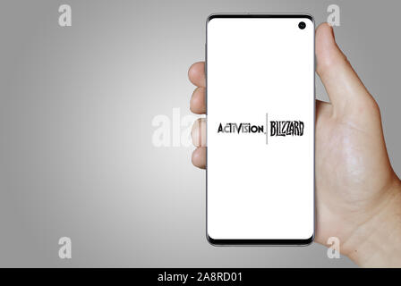 Logo of public company Activision Blizzard displayed on a smartphone. Grey background. Credit: PIXDUCE Stock Photo