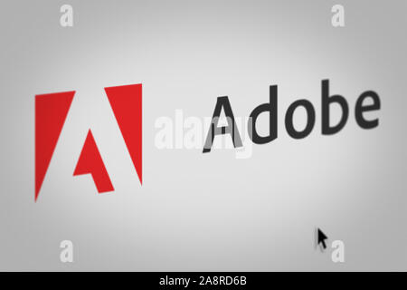 Logo of the public company Adobe Systems Inc displayed on a computer screen in close-up. Credit: PIXDUCE Stock Photo
