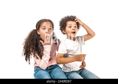 shocked african american sister and brother looking away isolated on white Stock Photo