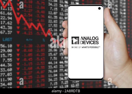 Logo of public company Analog Devices displayed on a smartphone. Negative stock market background. Credit: PIXDUCE Stock Photo