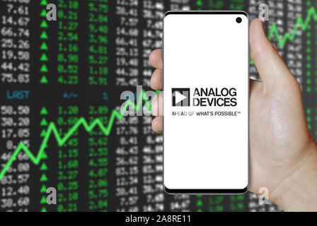 Logo of public company Analog Devices displayed on a smartphone. Positive stock market background. Credit: PIXDUCE Stock Photo