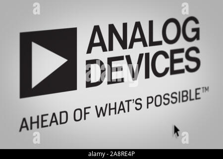 Logo of the public company Analog Devices displayed on a computer screen in close-up. Credit: PIXDUCE Stock Photo