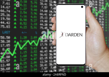 Logo of public company Darden Restaurants displayed on a smartphone. Positive stock market background. Credit: PIXDUCE Stock Photo