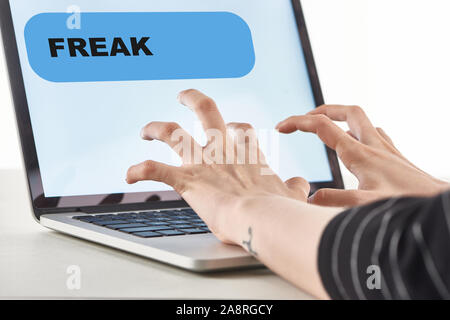 cropped view of girl typing on laptop keyboard with fresk message on screen, cyberbullying concept Stock Photo