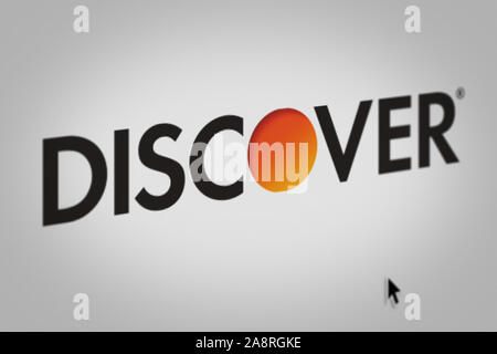 Logo of the public company Discover Financial Services displayed on a computer screen in close-up. Credit: PIXDUCE Stock Photo