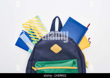 Blue school bag with different school supplies isolated on white Stock Photo