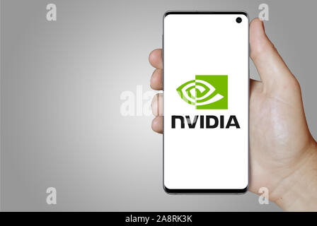 Logo of public company Nvidia Corporation displayed on a smartphone. Grey background. Credit: PIXDUCE Stock Photo