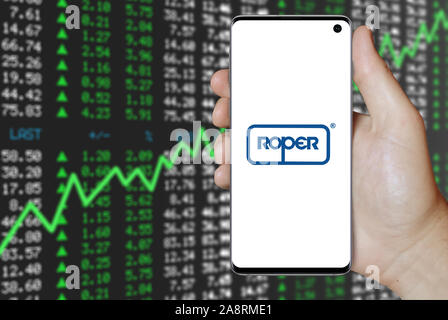 Logo of public company Roper Technologies displayed on a smartphone. Positive stock market background. Credit: PIXDUCE Stock Photo