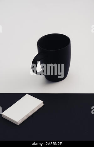 white business cards and black coffee cup on black and white background Stock Photo