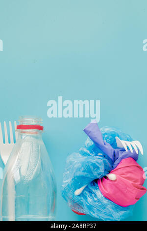 Top view of various kinds of disposable plastic waste on blue background, copy space Stock Photo