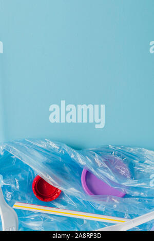 Top view of various kinds of disposable plastic waste on blue background, copy space Stock Photo