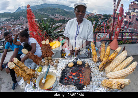 Colombian woman and her BBQ stand in Comuna 13 (also known as San Javier) in Medellin, Colombia. Stock Photo