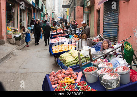 Hui women selling vegetables in a street market at the Muslim Quarter of Xining, China Stock Photo