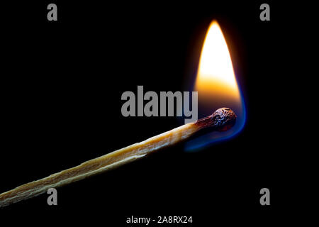Burning match on a dark background. Closeup. Stock Photo