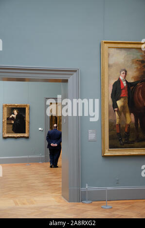 A security guard stands amongst paintings at The Metropolitan Museum of Art in Manhattan, New York City Stock Photo