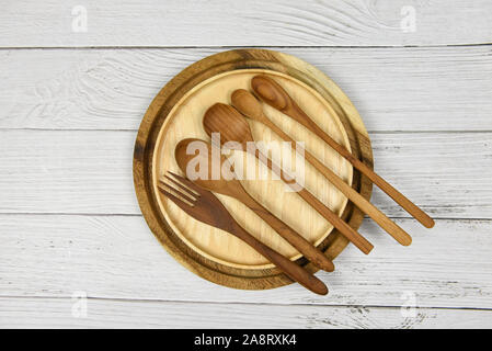 Natural kitchen tools wood products / Kitchen utensils background with spoon fork and dessert spoon various sizes on plate object utensil wooden conce Stock Photo