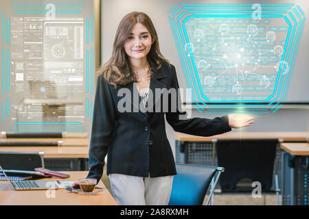 Asian businesswoman in casual suit present the polygonal brain shape of an artificial intelligence with various icon of smart city Internet of Things Stock Photo