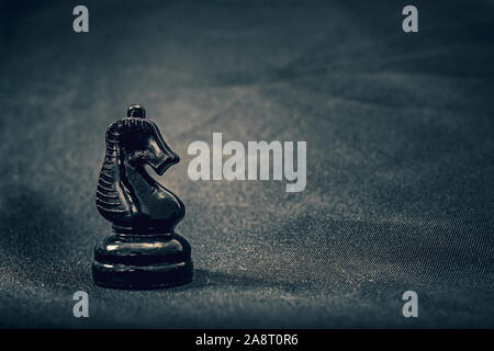 glass Black knight chess piece on dramatic background Stock Photo