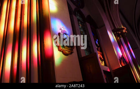 PUDUCHERRY (PONDICHERRY)/INDIA-FEBRUARY 22 2018:Sunlight colorfully penetrates the stained glass windows onto the ornately decorated walls of Basilica Stock Photo