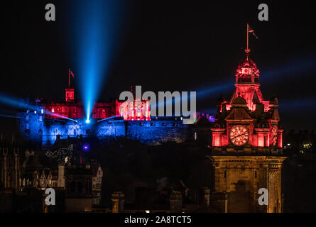 Edinburgh Castle and The Balmoral Clock are illuminated red ahead of Armistice Day in support of the Scottish Poppy Appeal. More than 120 Scottish landmarks, monuments and buildings will be glowing red for PoppyScotland's 'Light Up Red' Remembrance campaign, a tribute to Scotland's Armed Forces community past and present. Stock Photo