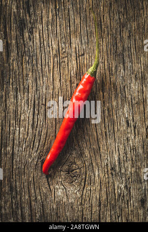 Red chili pepper on old wooden table. Top view. Stock Photo