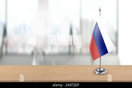 Russian flag is standing on a metal pole is at wooden office table. High resolution image is ready for social media, print or design crop needs. 3D re Stock Photo