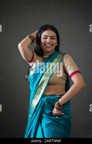 young woman dancing in saree Stock Photo