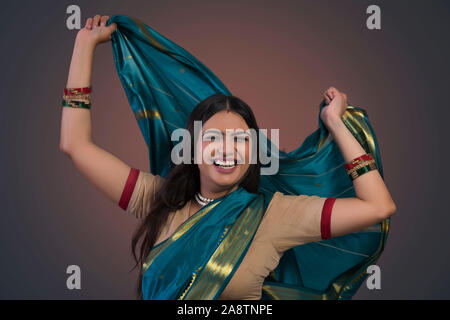 young woman dancing in saree Stock Photo