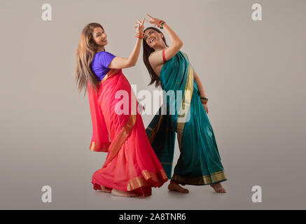 young women dancing in saree Stock Photo