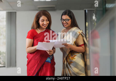 two employees analysing reports Stock Photo