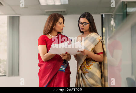 two employees analysing reports Stock Photo