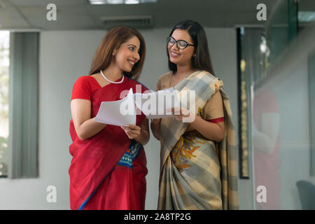 two employees analysing reports Stock Photo